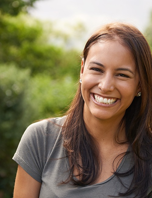 Woman standing outside and showing off smile