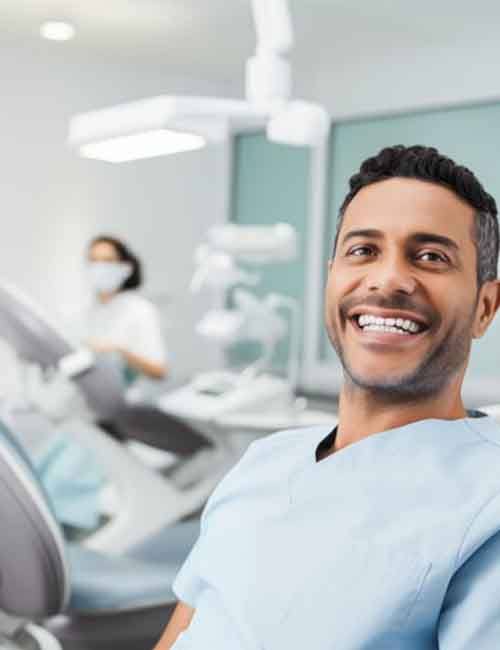 a dental patient smiling while visiting his dentist