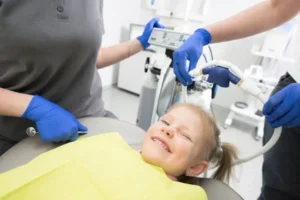 Smiling young girl in dentist’s chair